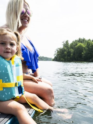 Mother and daughter on boat on lake in Minocqua Wisconsin